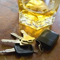 An alcoholic drink with car keys next to it. Should this person drive drunk and get in an accident, they may face a Tucson DUI Accident Lawyer