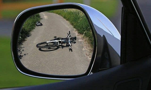 Rider of this bike on the road in rearview mirror wonders what should I do if I get hit by a car on my bike